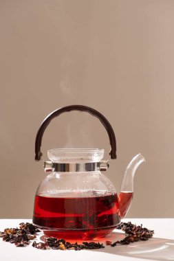 Red hibiscus tea from the petals of a Sudanese rose in a glass teapot.