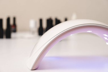 Ultraviolet LED lamp for drying gel nail polish and jars with gel polishes. Manicure and pedicure