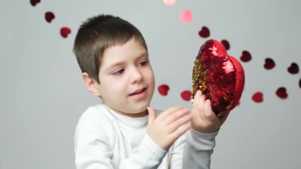 Χαριτωμένο Ετών Μελαχρινή Αγόρι Παίζει Μια Καρδιά Μαξιλάρι Πούλιες Για — Αρχείο Βίντεο