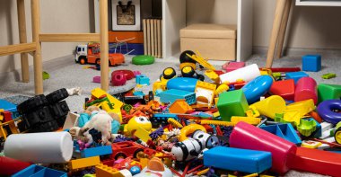 An abundance of toys in the childrens room, a lot of plastic multi-colored parts from designers, spare parts for toys, figurines and cubes clipart