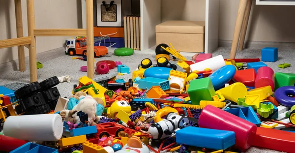 An abundance of toys in the childrens room, a lot of plastic multi-colored parts from designers, spare parts for toys, figurines and cubes