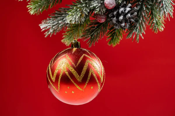 Shiny Ball Snow Covered Branch Christmas Tree Red Background Place — Stock Photo, Image