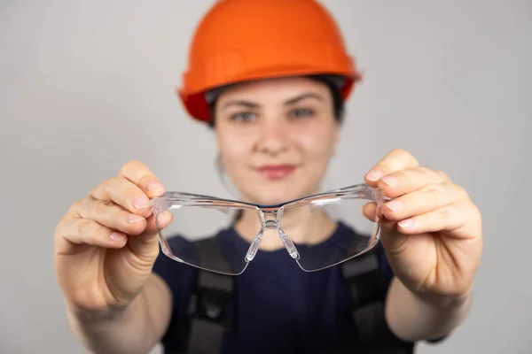 Woman Builder Engineer Holds Goggles White Background — Stock Photo, Image