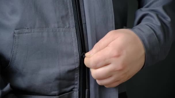 Man Fastens Zipper Protective Overalls Close — Stock Video