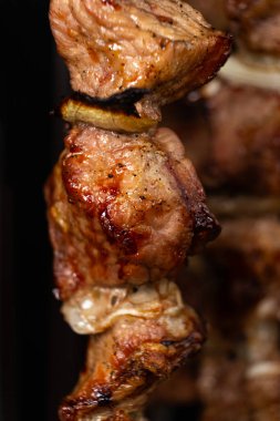 Elektrikli kebap makinesinde dikey şişte domuz eti pişirmek.