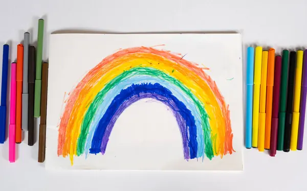 Drawing of a 6 year old child - a rainbow drawn with felt-tip pens in a sketchbook.