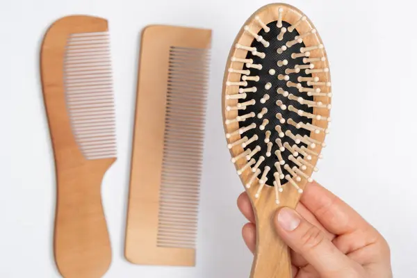 Wooden Comb In Womans Hand, Natural Products In Hair Care.