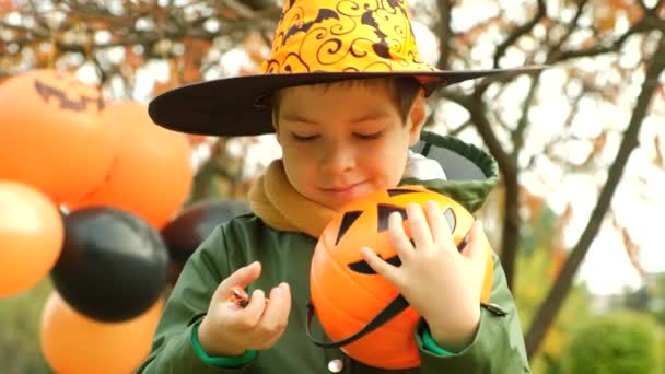 Happy Halloween Little Boy Taking Holiday Candy Out Pumpkin Shaped — Stock Video