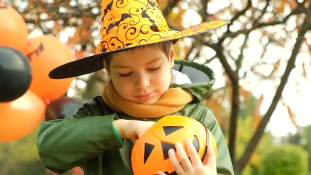 Happy Halloween Little Boy Taking Holiday Candy Out Pumpkin Shaped — Stock Video