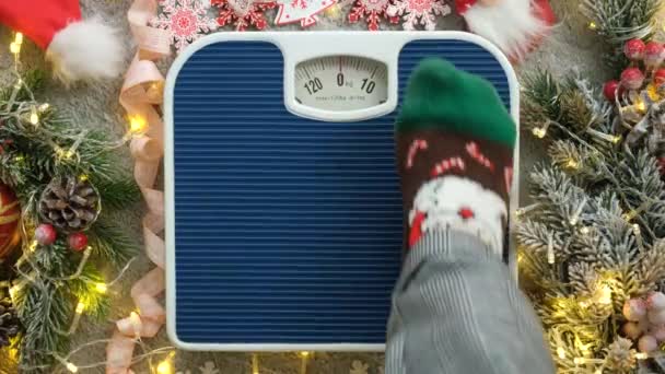 Woman Christmas Socks Stands Scales Weighs Herself Gluttony Holidays — Stock Video