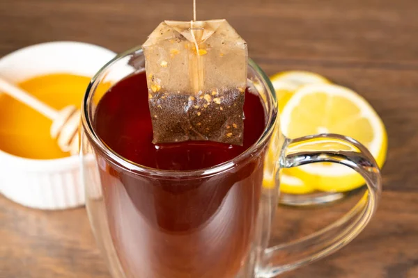 Preparation tea from a tea bag in a glass cup