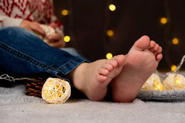 Bare feet of a small child. Cozy Christmas mood
