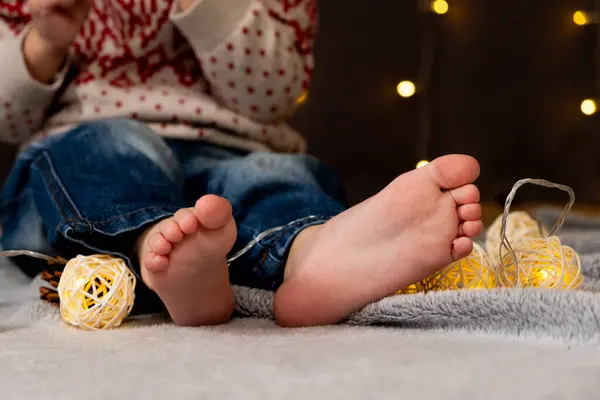 Bare feet of a small child. Cozy Christmas mood
