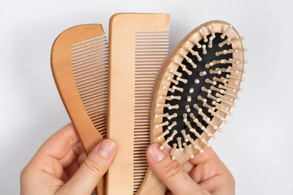 Wooden Combs In Womans Hand, Natural Products In Hair Care.