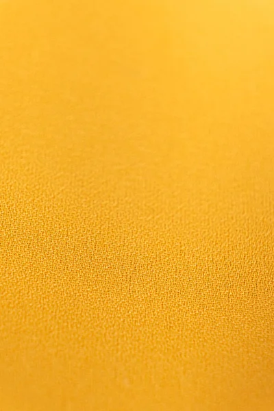 Polyester synthetic fabric, macro fiber yellow fabric, selective focus.
