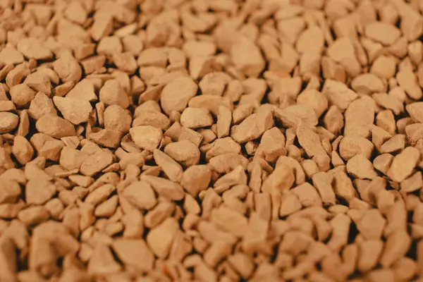 Background of freeze-dried granulated instant coffee macro close-up