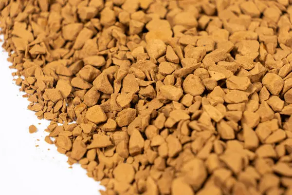 Background of freeze-dried granulated instant coffee macro close-up
