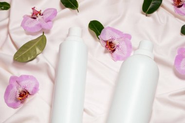 Sıvı çamaşır deterjanı ve yumuşatıcı yatak örtüsü, orkide çiçekleri, üst manzara..