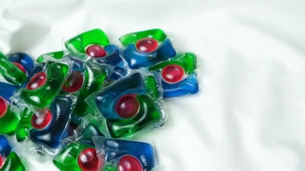 Laundry Pod Slowly Falling Satin Fabric Slow Motion Top View — Stock Video