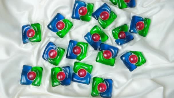 Lots Laundry Pods Satin Fabric Close Top View — Stock Video
