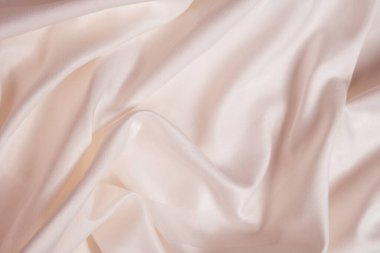 Dalgalar ve buruşuk doğal saten pembe bej kumaş desenleri.