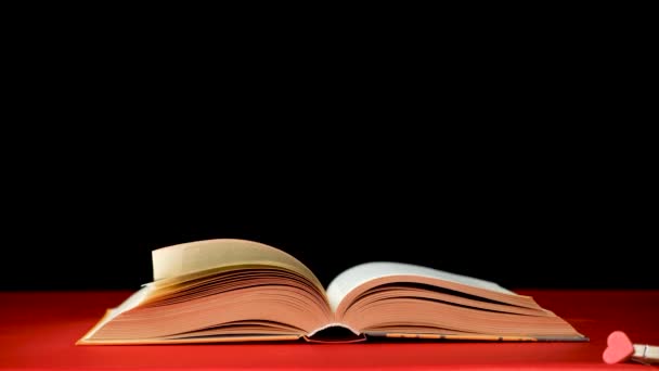 Quickly Flipping Pages Thick Book Red Black Background — Stock Video