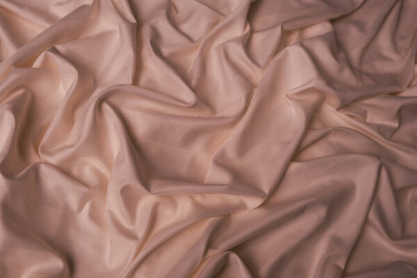 Атласная ткань пыльно-розовый бежевый цвет, абстрактный фон, волны и узоры