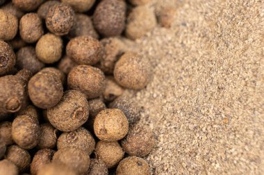 Ground black pepper and peppercorns close-up clipart