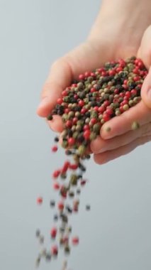 Eller biber serpiştiriyor kırmızı, yeşil, beyaz ve siyah biber, dikey yavaş çekim