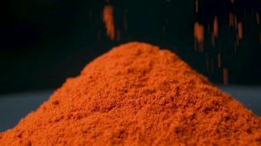 Baharatlı tütsülenmiş kırmızı biber siyah arka plana makro döker