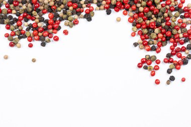 Beyaz arkaplanda kırmızı, yeşil, beyaz ve siyah biberler, metin için boşluk kopyala.