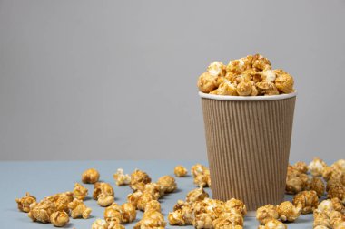 Sweet caramelized popcorn in a bucket. Place for text. clipart