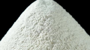 Siyah arkaplanda beyaz buğday ununun makro dönüşü.
