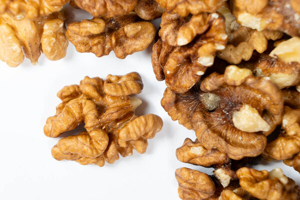 Shelled walnuts on a white background close-up.