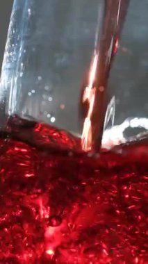 Kırmızı şarap sirkesinin makro yavaş çekimi, cam kabarcıklar, kabarcıklar.