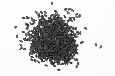 Black sesame seeds scattered on a white background macro top view. clipart