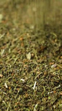 Organik kurutulmuş baharatlı yapraklar, makro dökme, dikey yavaş çekim..