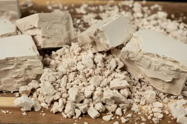 Sıkıştırılmış taze maya küpleri ahşap arka planda yakın plan