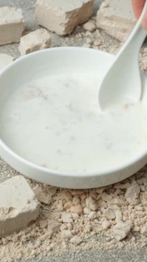 Bir kaşık dolusu taze mayayı ılık sütle karıştırıp mayalı hamur mayası yapmak..