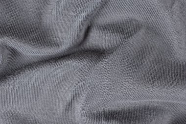 Pamuktan oluşmuş gri kumaşın makro dokusu ve hafif elastik eklenmiş.