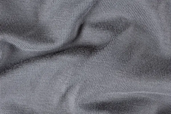 Pamuktan oluşmuş gri kumaşın makro dokusu ve hafif elastik eklenmiş.