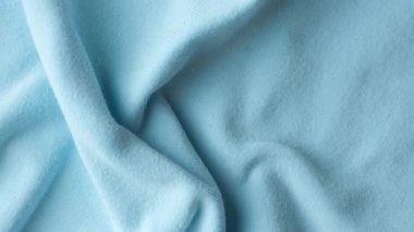Pamuktan oluşan mavi kumaşın makro dokusu ve hafif bir tayt eklemesi