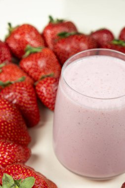 Süt, dondurma ve çilekli taze çilekli milkshake.