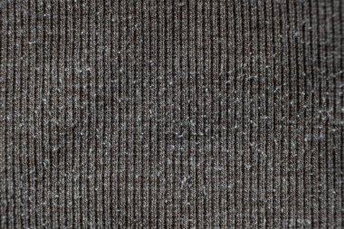 Gri kumaşın makro dokusu. Yüzeyde çok fazla yığılma ve hasar var.