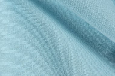 Pamuktan oluşan mavi kumaşın makro dokusu ve hafif bir tayt eklemesi