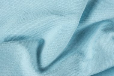 Pamuktan oluşan mavi kumaşın makro dokusu ve hafif bir tayt eklemesi