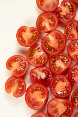 Küçük olgun domatesler ikiye bölünmüş makro üst görünüm.