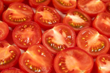 Taze kesilmiş küçük domateslerin yakın çekimi. Canlı Kırmızı Aşçılık Arkaplanı