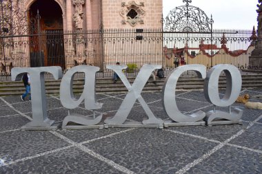 Taxco, Mexico - November 10 2022: The iconic Taxco silvered letters in the heart of the town