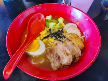 Lezzetli ramen, domuz eti, haşlanmış yumurta ve avokado.